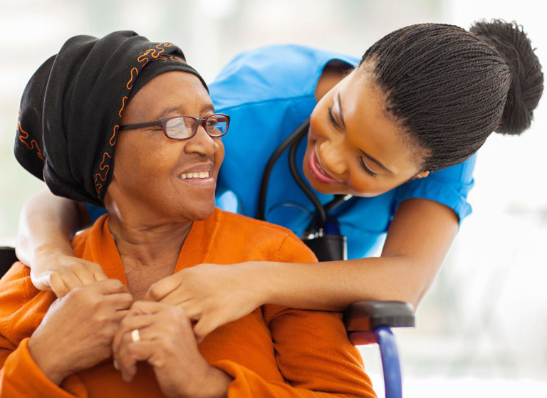 Support worker and participant sharing a relaxed moment in the community